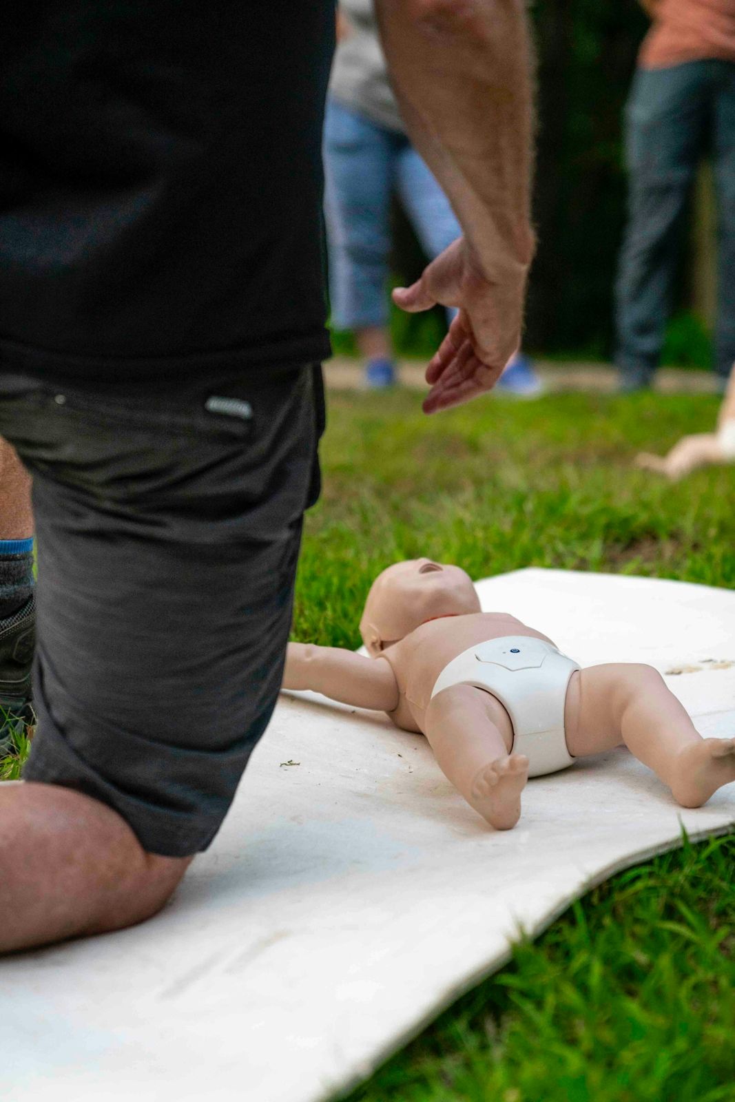 Practising infant CPR on a baby manikin