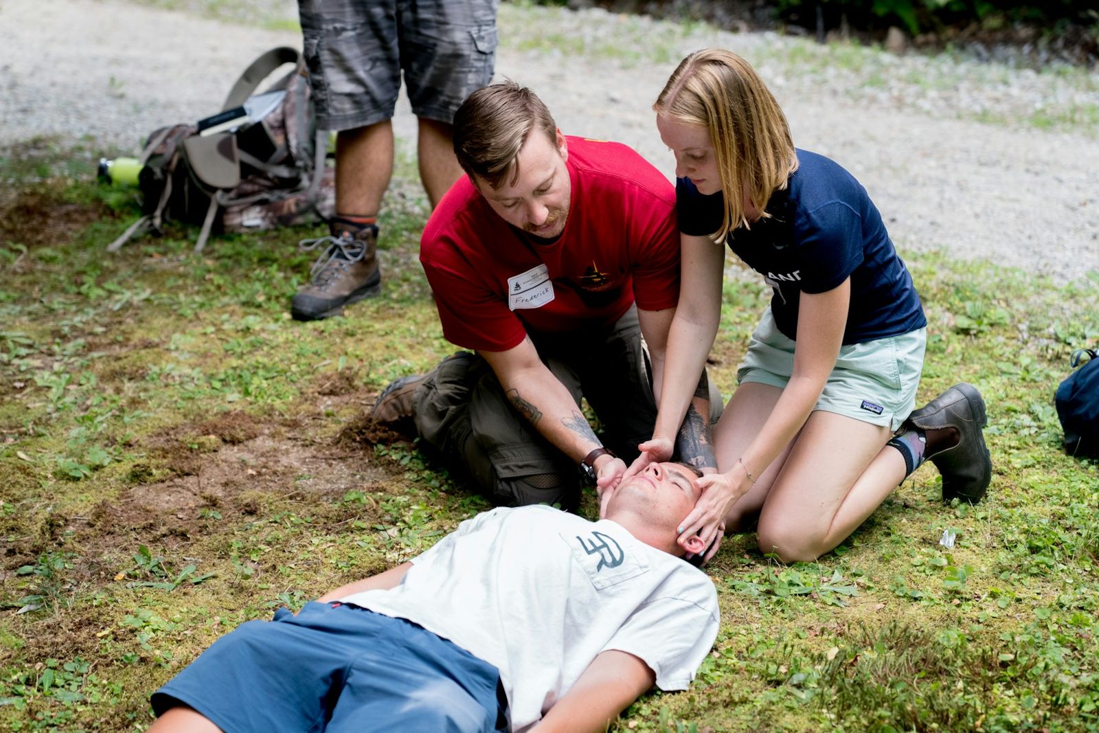 Two people practising a first aid response on a volunteer